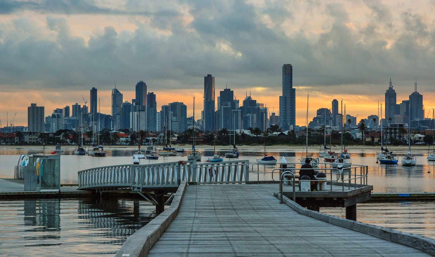 Melbourne's skyline at sunset seen from St Kilda Pier, with boats in the harbour